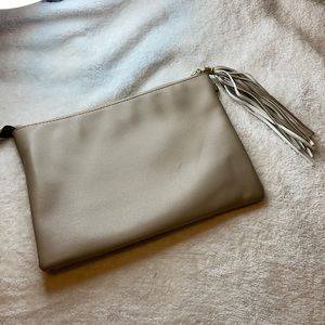 Taupe colored clutch with tassel